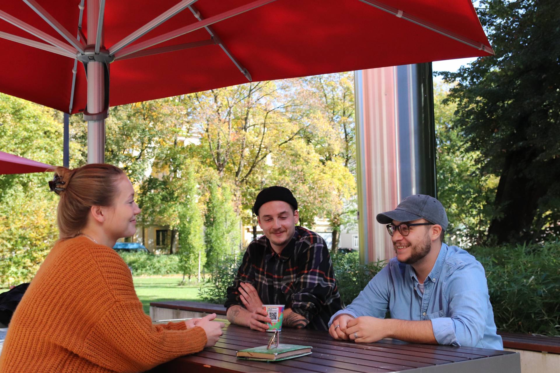 Carolin, Simon (Mitte) und Kilian (r.) im Gespräch über ihr Studium der Sozialen Arbeit. 